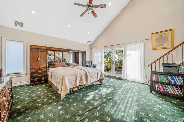 a spacious bedroom with a bed a flat screen tv and a walk in closet