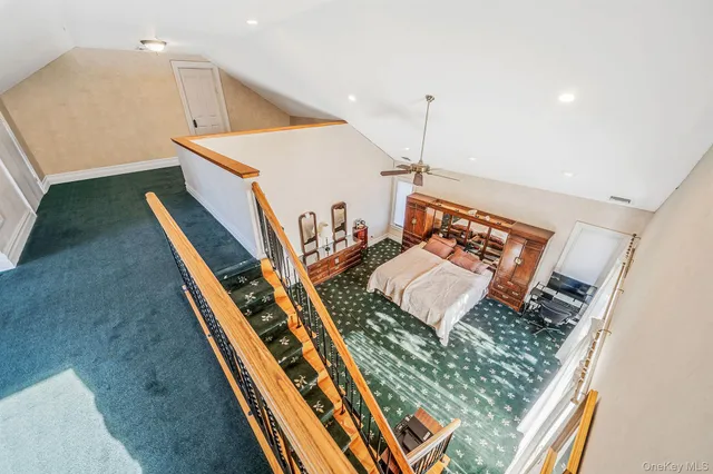 a bathroom with a tub a mirror and a shower