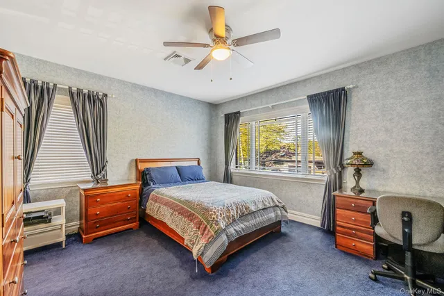 a bathroom with a granite countertop toilet sink and mirror