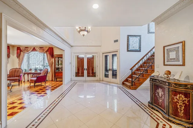 a view of an entryway with wooden floor and a livingroom view