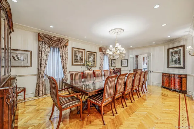 a dining room with furniture and a chandelier