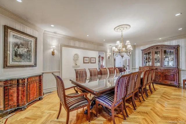 a view of a dining room with furniture and chandelier