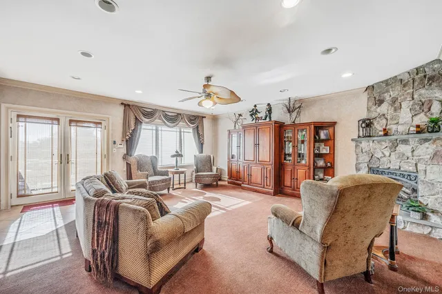 a living room with furniture a fireplace and a chandelier