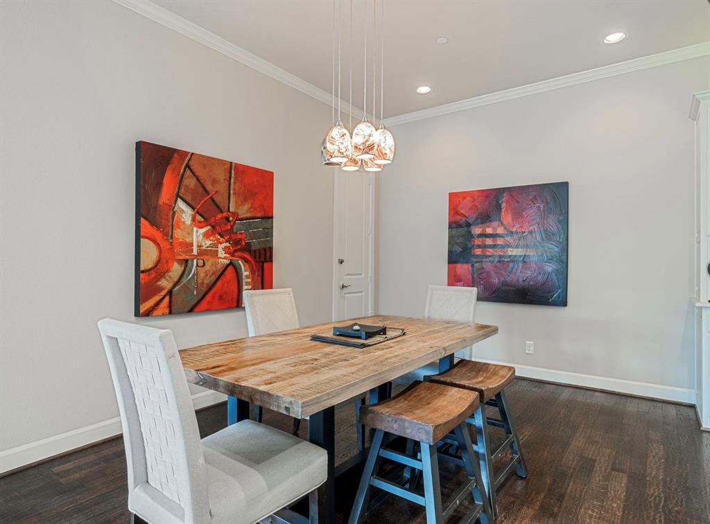 5001 Meridian Lane, Unit 2103 Addison, TX 75001 - Photo 6 of 26 Dining area featuring dark wood-finish flooring, light gray walls, and white crown molding