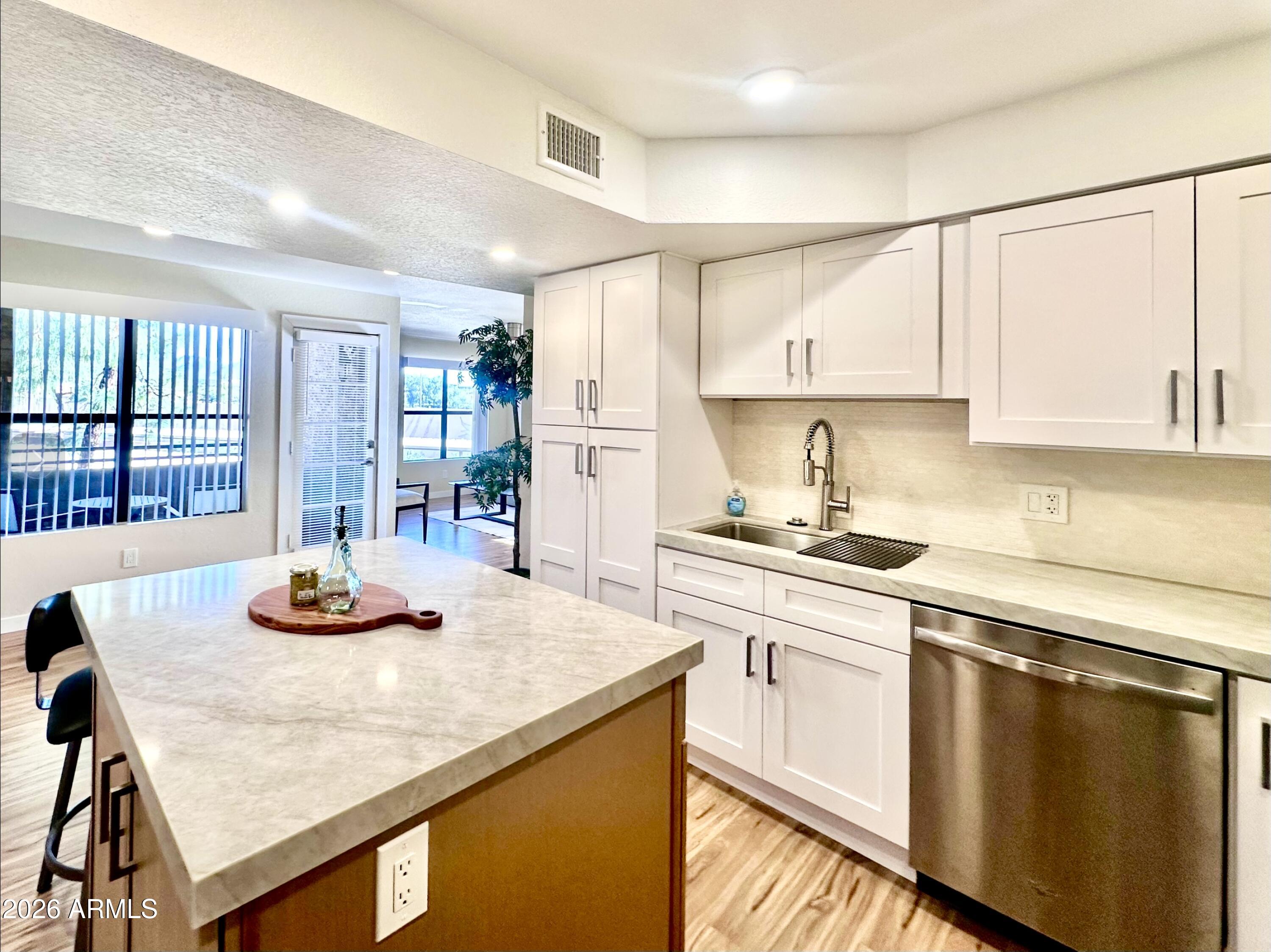 a kitchen with appliances cabinets and a counter top space