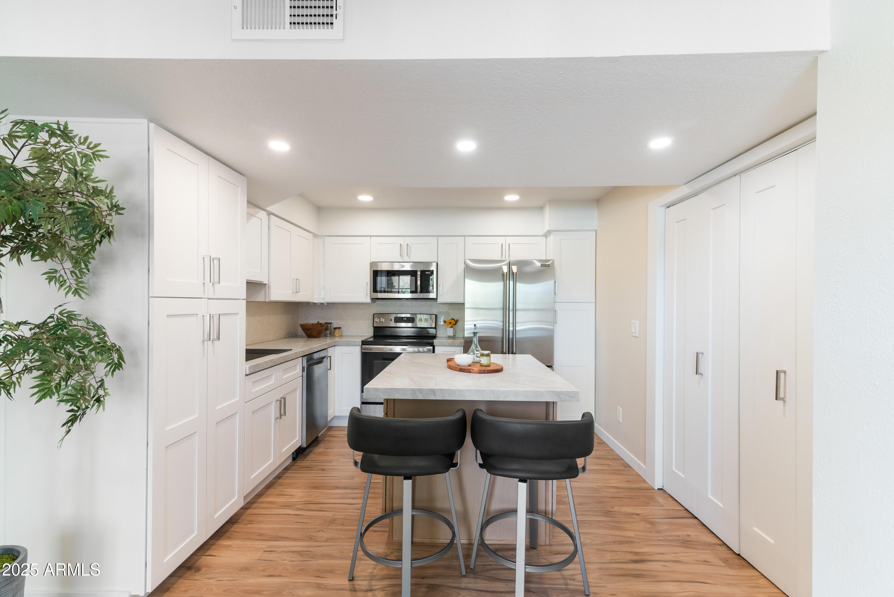 8787 East Mountain View Road, Unit 2101 Scottsdale, AZ 85258 - Photo 11 of 39 a kitchen with stainless steel appliances kitchen island granite countertop a sink and cabinets