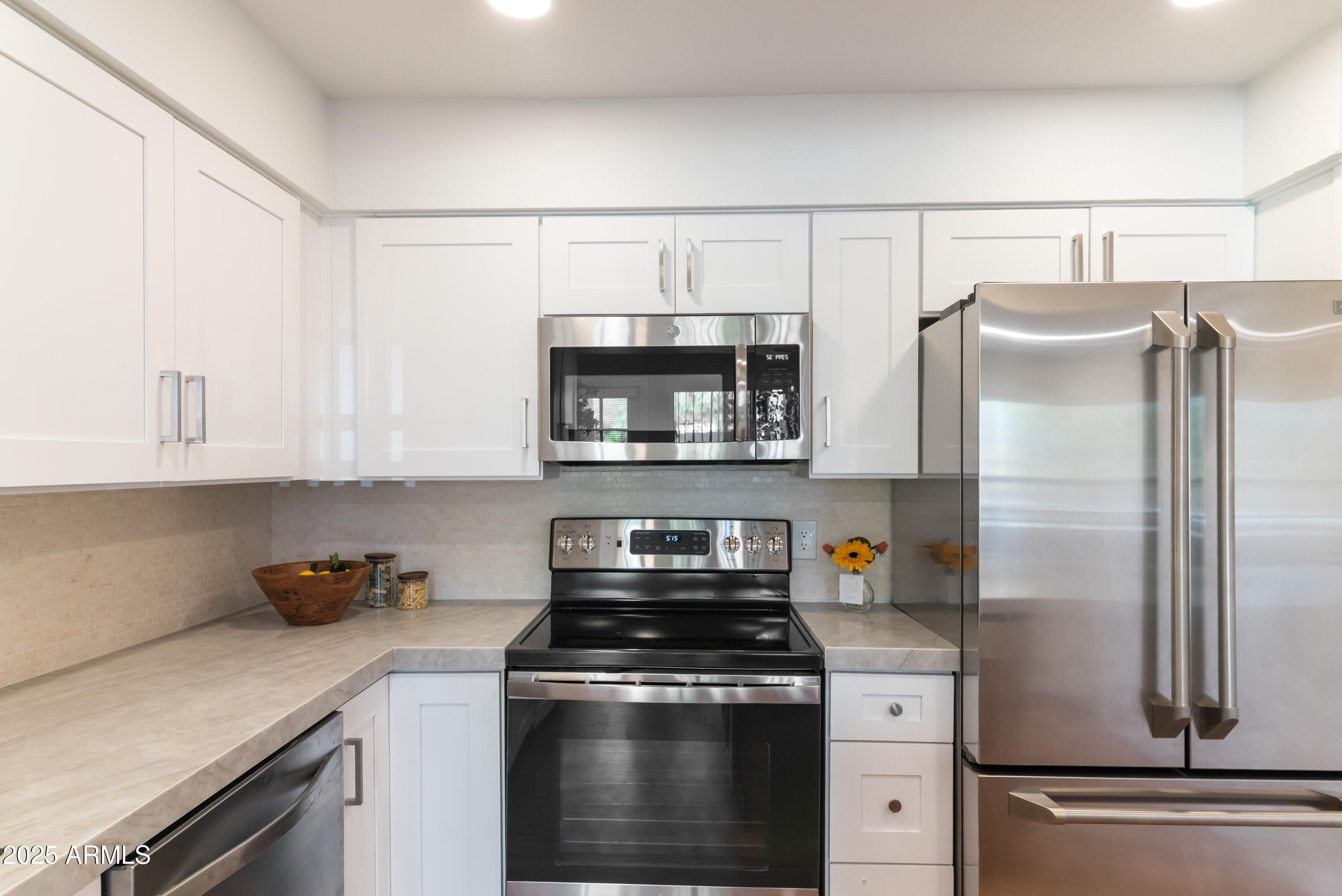 8787 East Mountain View Road, Unit 2101 Scottsdale, AZ 85258 - Photo 12 of 39 a kitchen with cabinets and stainless steel appliances