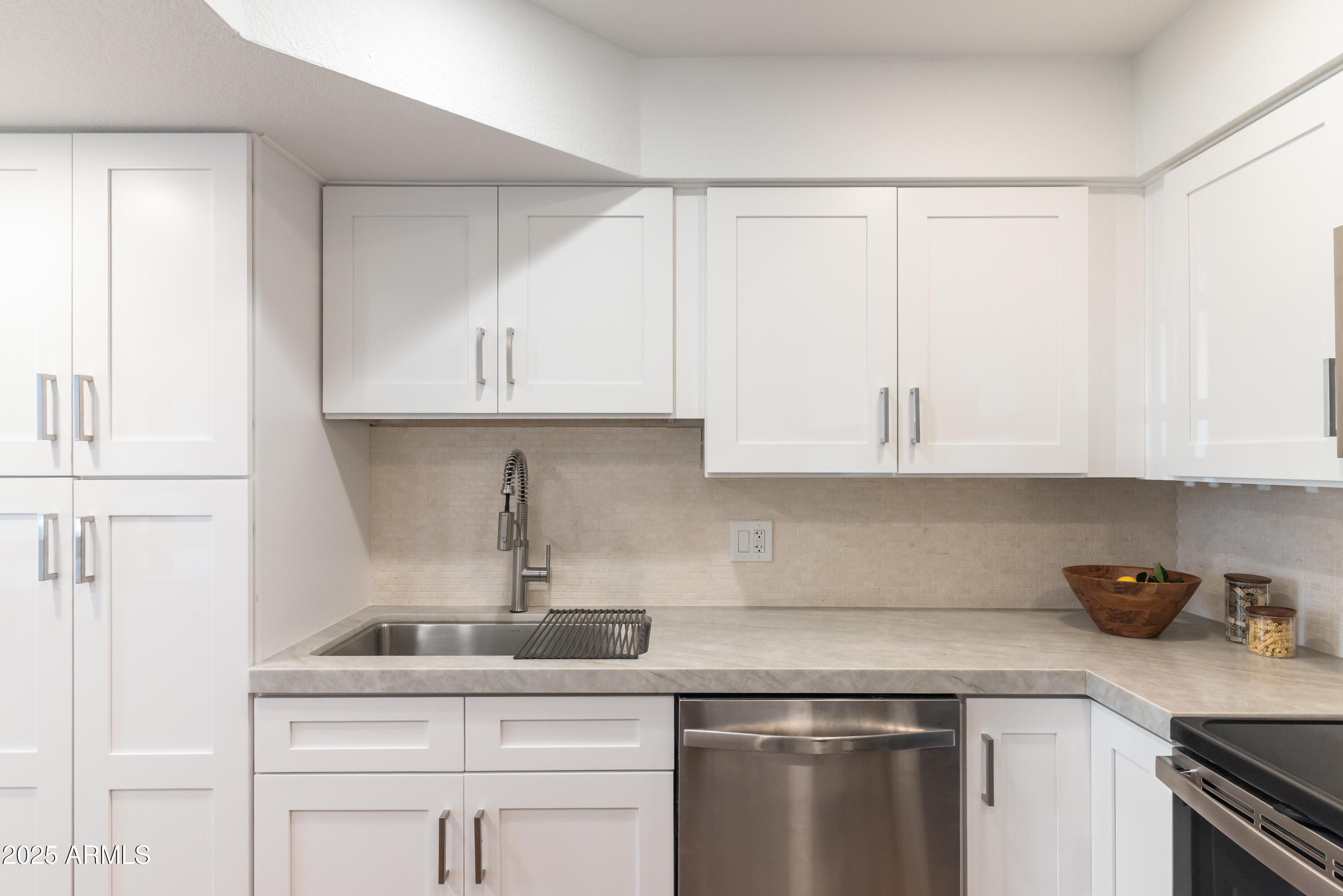 8787 East Mountain View Road, Unit 2101 Scottsdale, AZ 85258 - Photo 13 of 39 a kitchen with white cabinets and sink