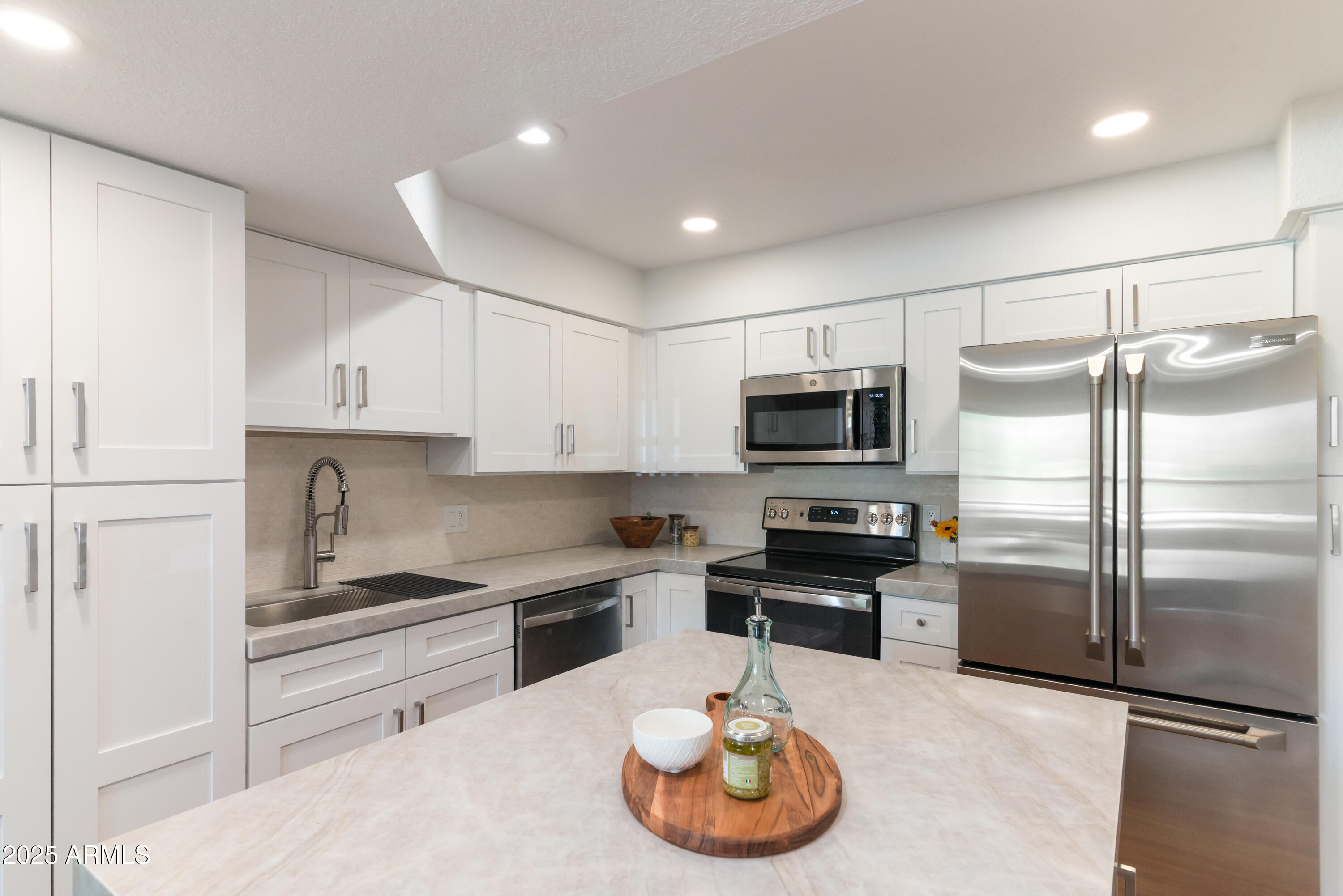 8787 East Mountain View Road, Unit 2101 Scottsdale, AZ 85258 - Photo 14 of 39 a kitchen with granite countertop stainless steel appliances and wooden cabinets