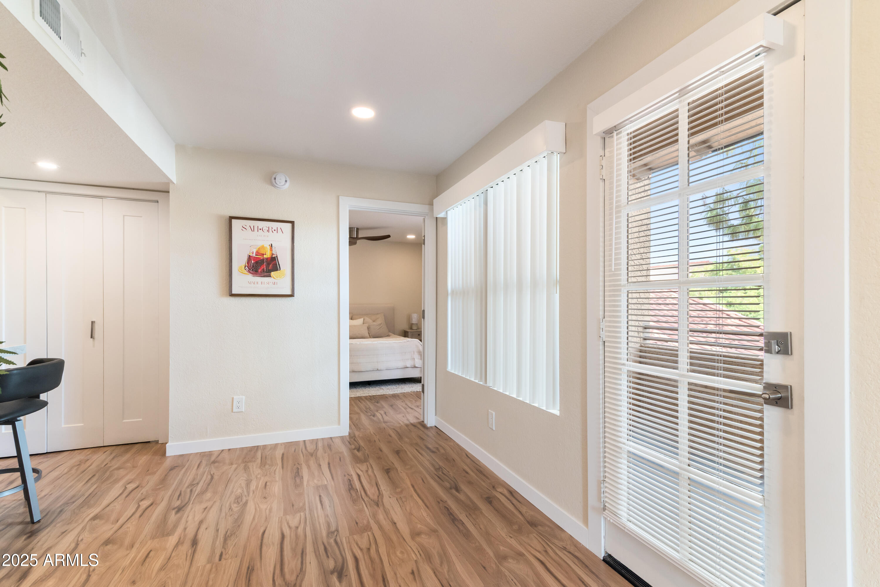 8787 East Mountain View Road, Unit 2101 Scottsdale, AZ 85258 - Photo 24 of 39 a view of a hallway with wooden floor and a bathroom