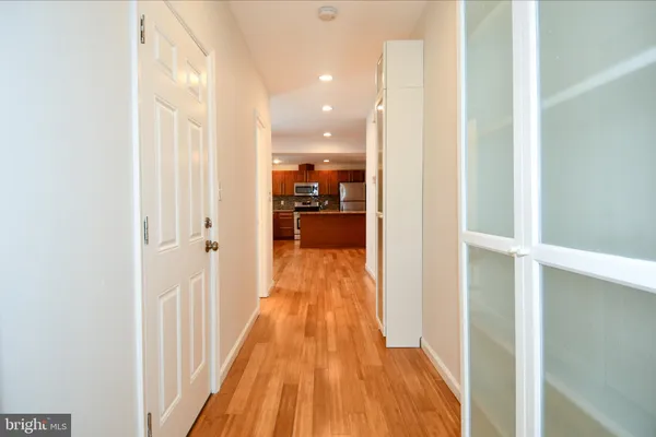 a kitchen with granite countertop a sink a counter top space appliances and cabinets