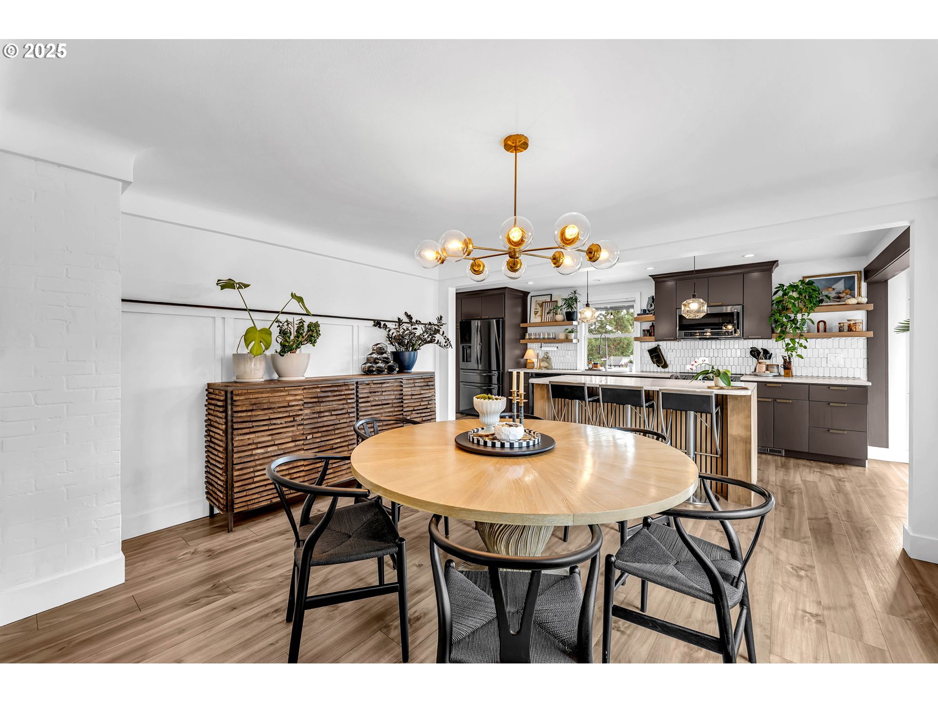 205 South Hillhurst Road Ridgefield, WA 98642 - Photo 14 of 43 a view of a dining room with furniture and wooden floor