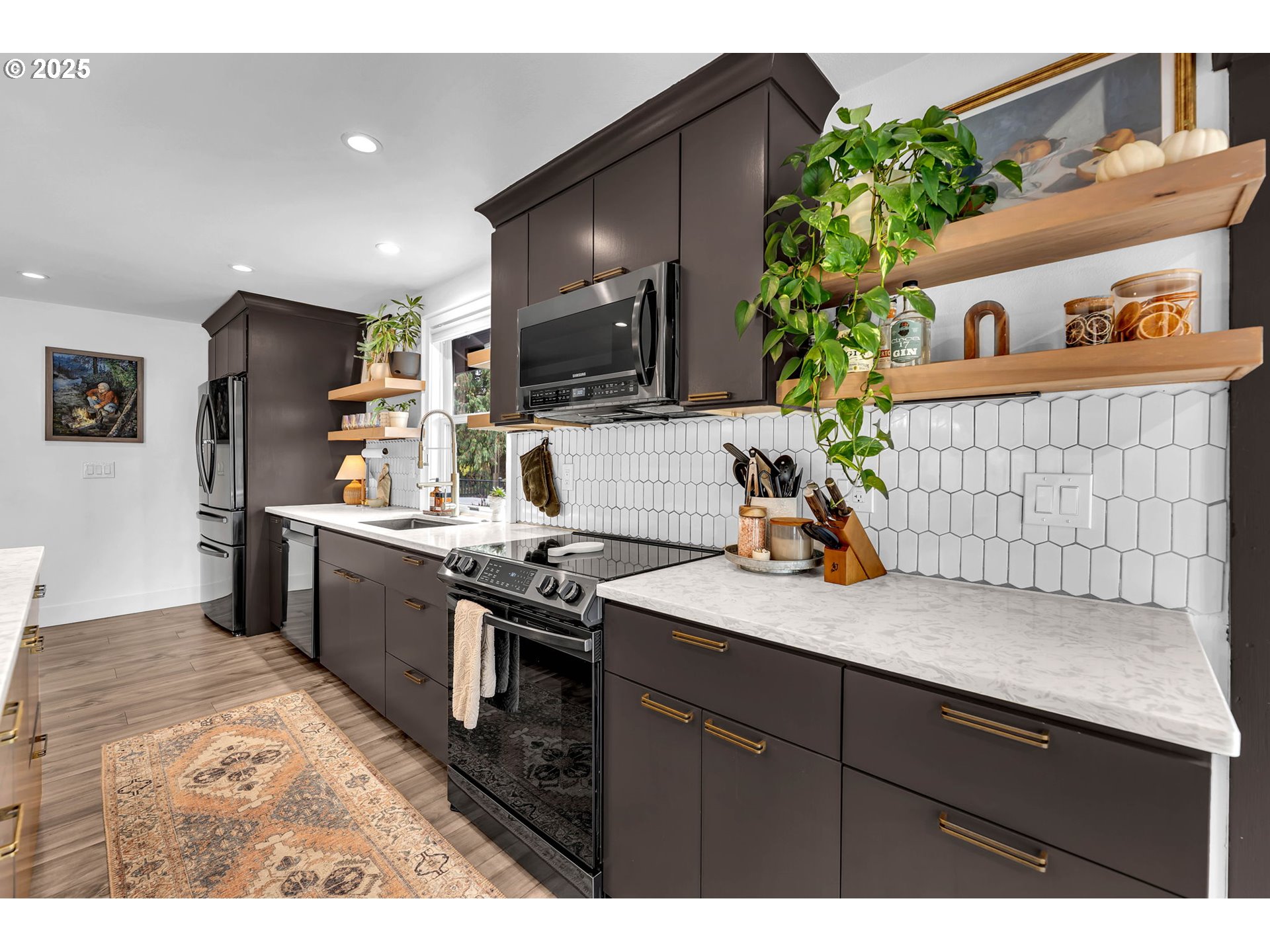 205 South Hillhurst Road Ridgefield, WA 98642 - Photo 22 of 43 a kitchen with stainless steel appliances kitchen island granite countertop a sink stove and refrigerator