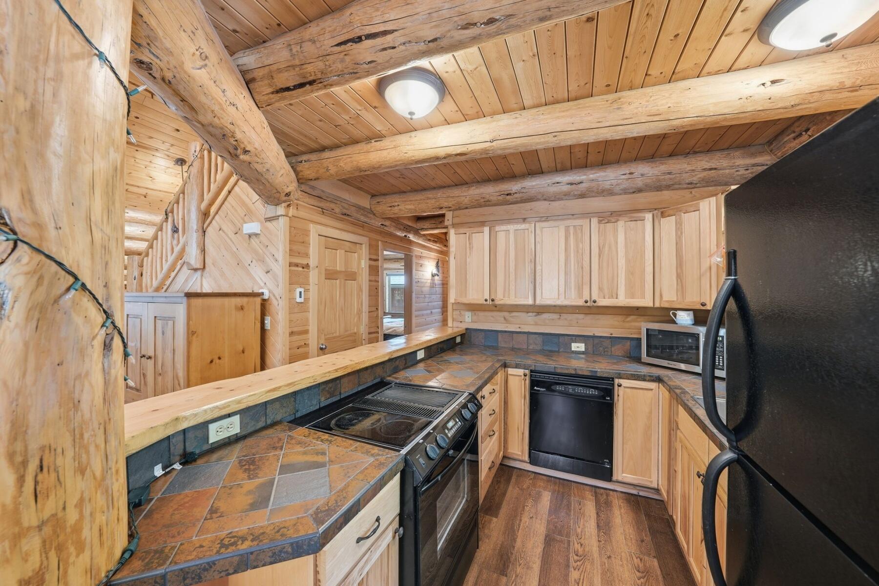 14177 Whitewater Loop La Pine, OR 97739 - Photo 8 of 38 a kitchen with stainless steel appliances granite countertop a sink a stove and a refrigerator