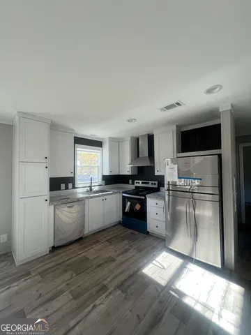 a bathroom with a granite countertop sink a mirror and shower