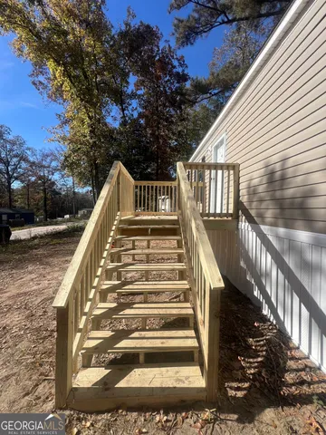 a view of a small yard with wooden fence