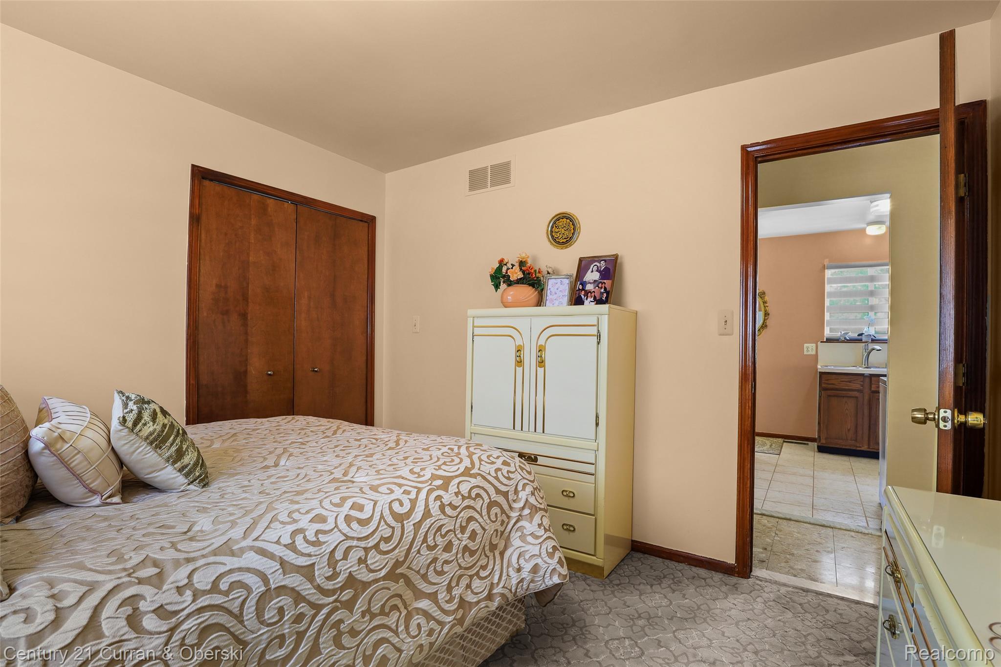 5296 Chase Road Dearborn, MI 48126 - Photo 11 of 36 Room featuring neutral wall paint, wood-finish bi-fold closet doors, and patterned carpeting