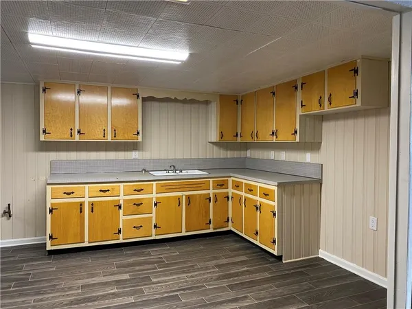 a kitchen with stainless steel appliances granite countertop wooden cabinets a sink and dishwasher