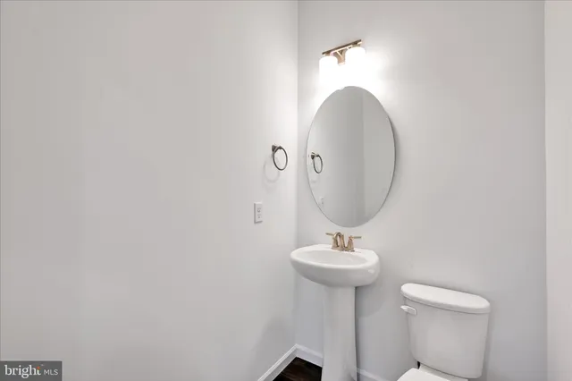 a bathroom with a sink a mirror and a toilet