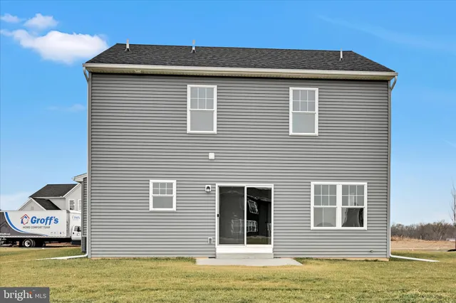 a view of a house with a yard and sitting area