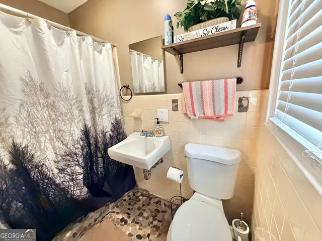 a white toilet sitting next to a bathroom sink