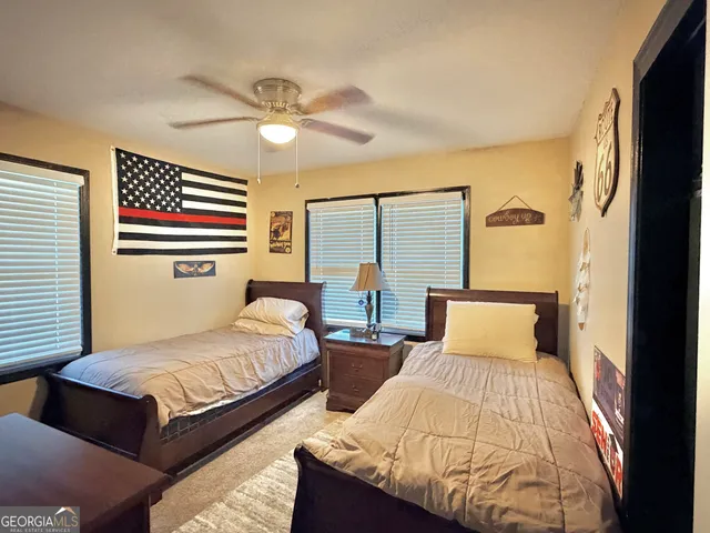 a bedroom with two beds and a chandelier