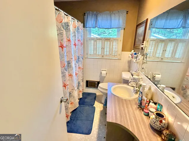 a bathroom with a sink a bathtub and a window