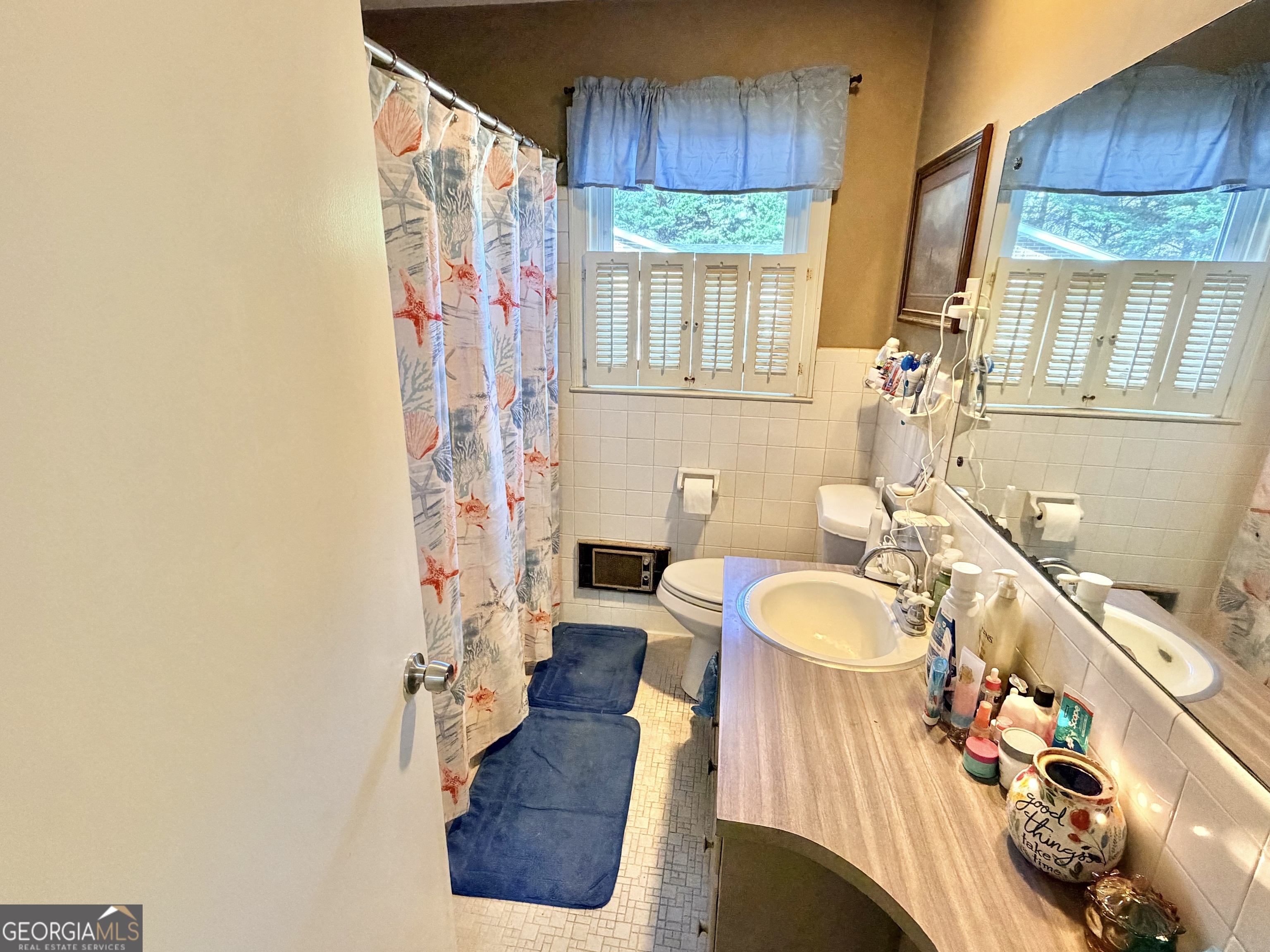 326 Remsdale Road Toccoa, GA 30577 - Photo 14 of 33 a bathroom with a sink a bathtub and a window