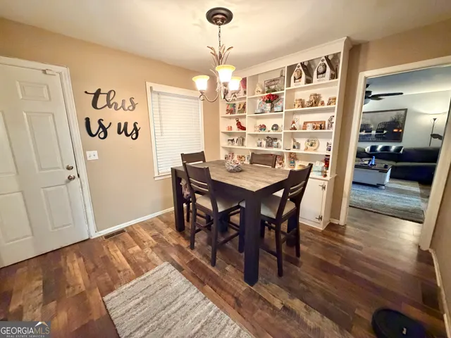 a view of a dining room with furniture and wooden floor