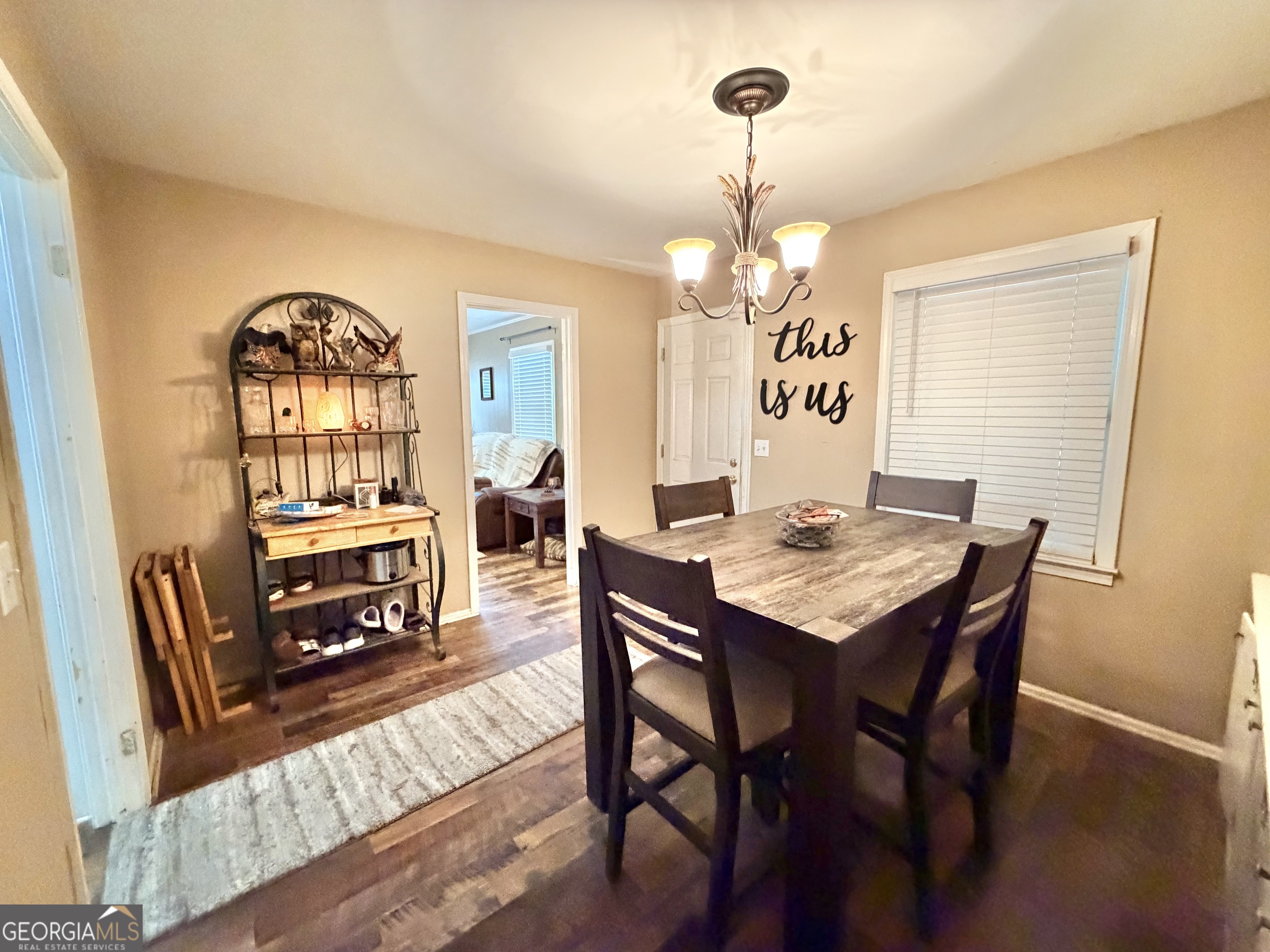 326 Remsdale Road Toccoa, GA 30577 - Photo 19 of 33 a view of a dining room with furniture a chandelier and wooden floor