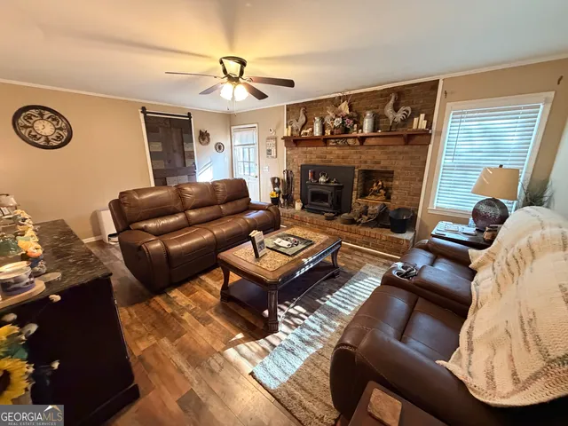 a living room with furniture a fireplace and a flat screen tv