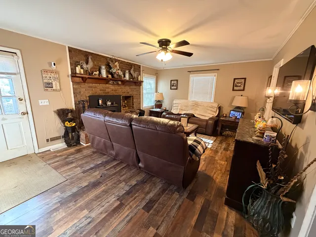 a living room with furniture a fireplace and a flat screen tv