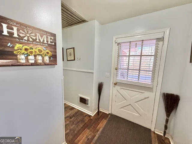 a view of an entryway with wooden floor