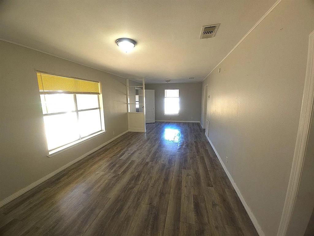 405 Northeast 24th Paris, TX 75460 - Photo 2 of 10 a view of empty room with wooden floor and fan