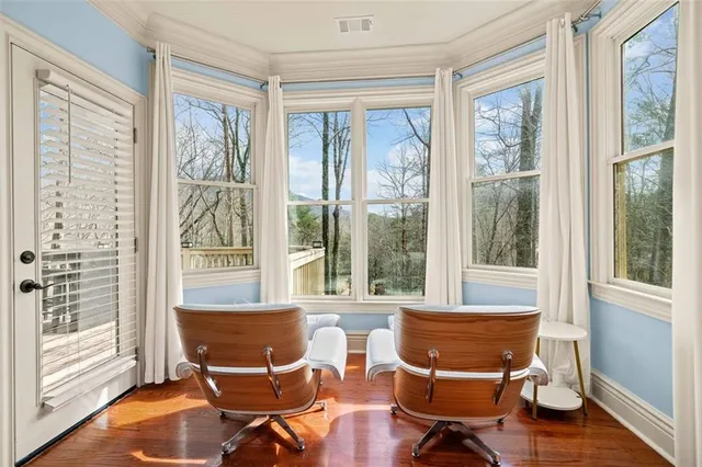 a kitchen with white cabinets and window