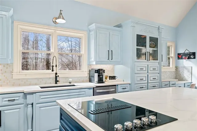 a view of a livingroom with wooden floor and furniture