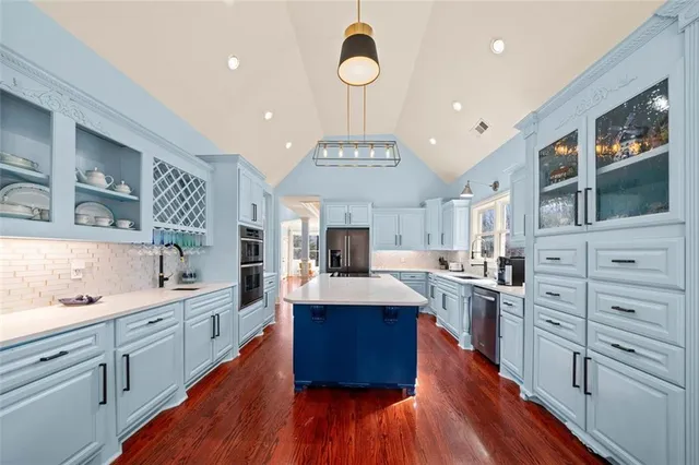 a view of an empty room with wooden floor stairs and a window