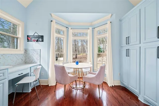 a living room with furniture a fireplace and a kitchen view