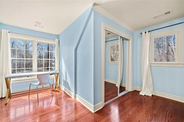 a sign that is sitting in front of a tree