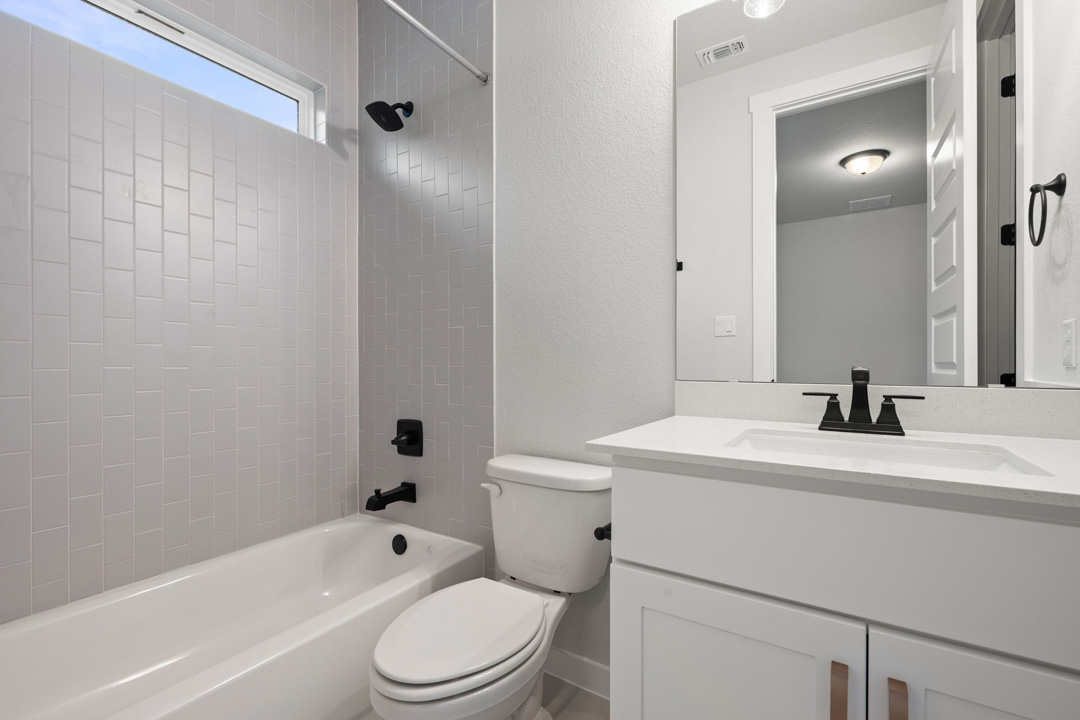 16201 Smithers Road Manor, TX 78653 - Photo 32 of 40 a bathroom with a sink a toilet and shower