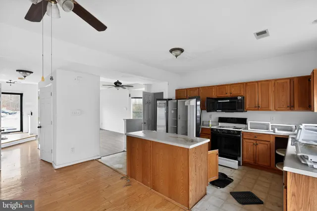 a kitchen with stainless steel appliances a stove a refrigerator and cabinets