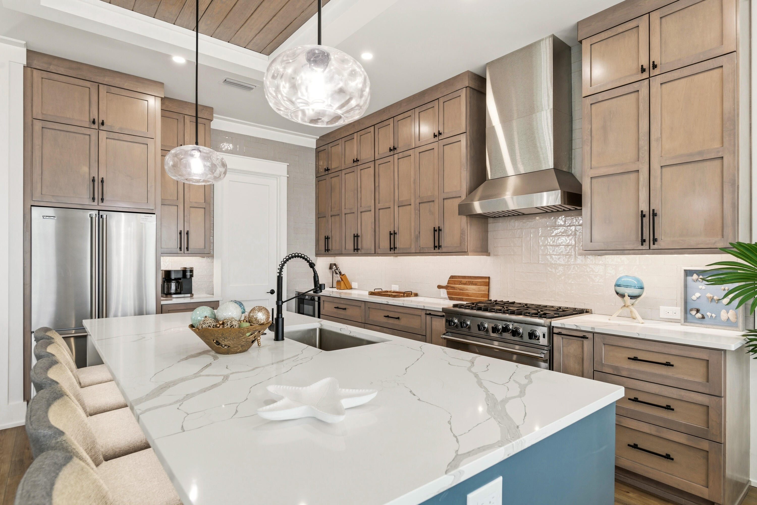 16416 Front Beach Road Panama City Beach, FL 32413 - Photo 16 of 46 a kitchen with stainless steel appliances a stove a sink and cabinets