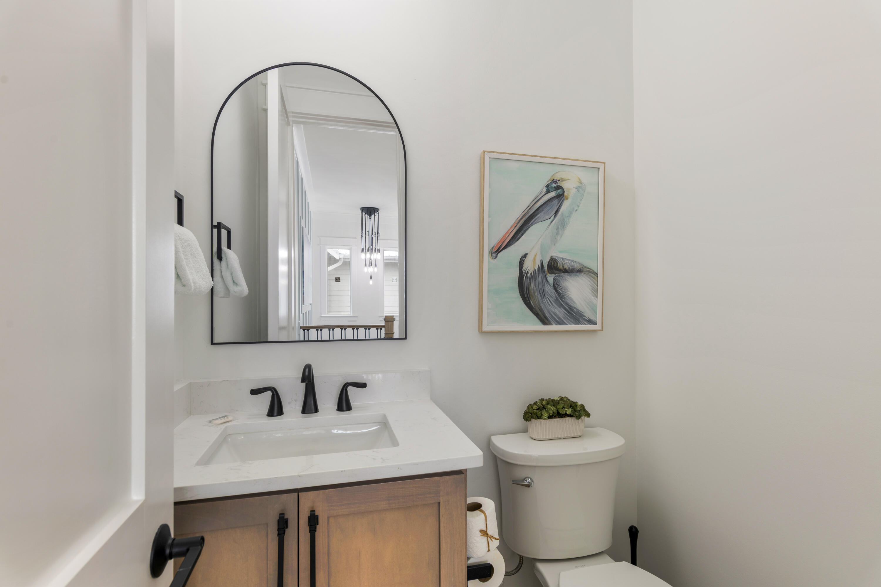 16416 Front Beach Road Panama City Beach, FL 32413 - Photo 17 of 46 a bathroom with a sink mirror and toilet
