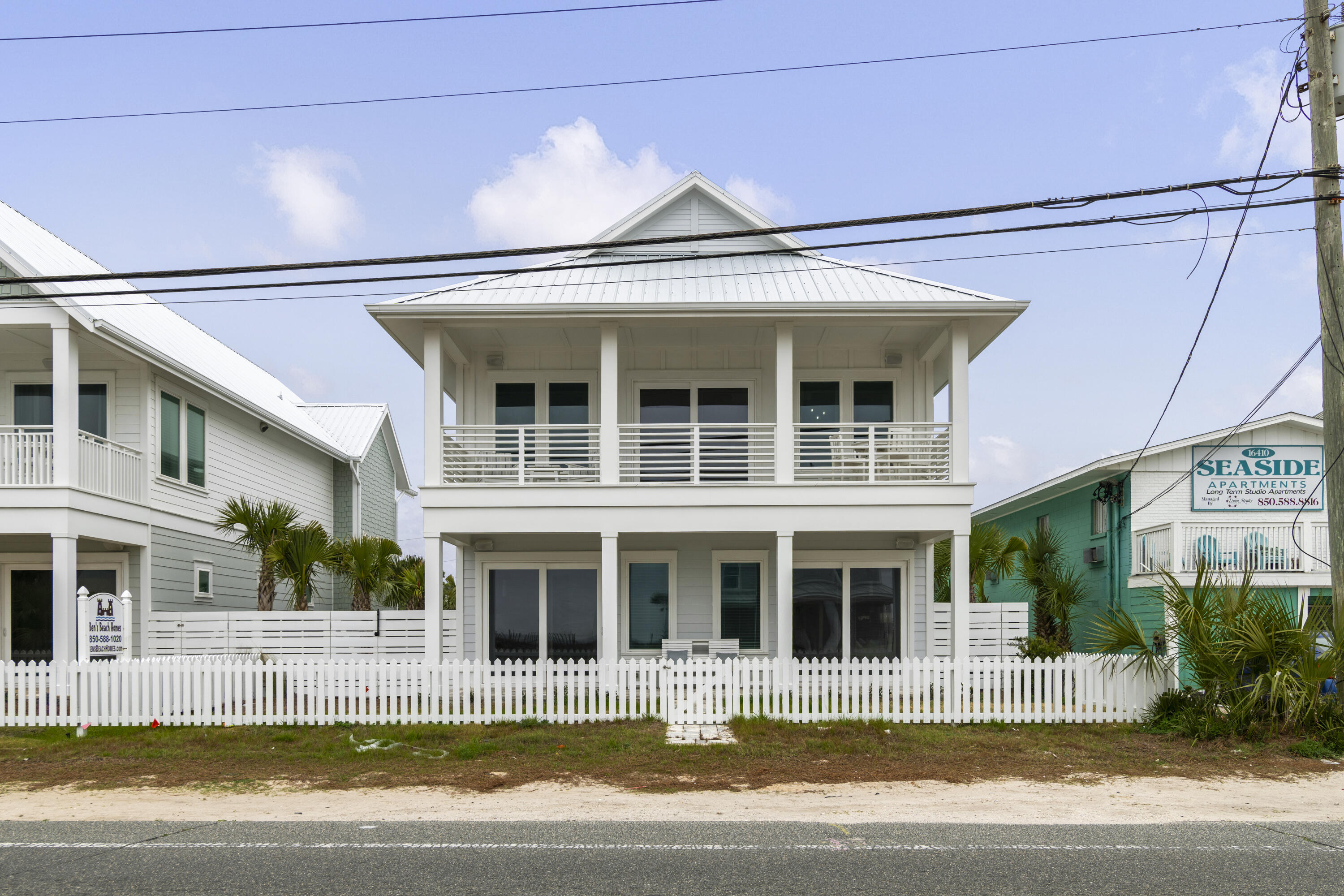 16416 Front Beach Road Panama City Beach, FL 32413 - Photo 42 of 46 a view of a white building with swimming pool in front of it