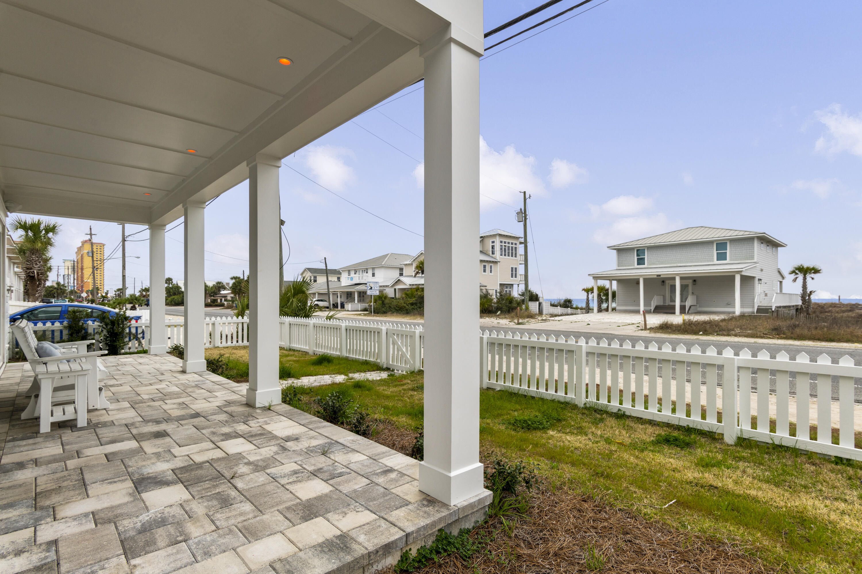 16416 Front Beach Road Panama City Beach, FL 32413 - Photo 43 of 46 a view of a house with a floor to ceiling window next to a yard