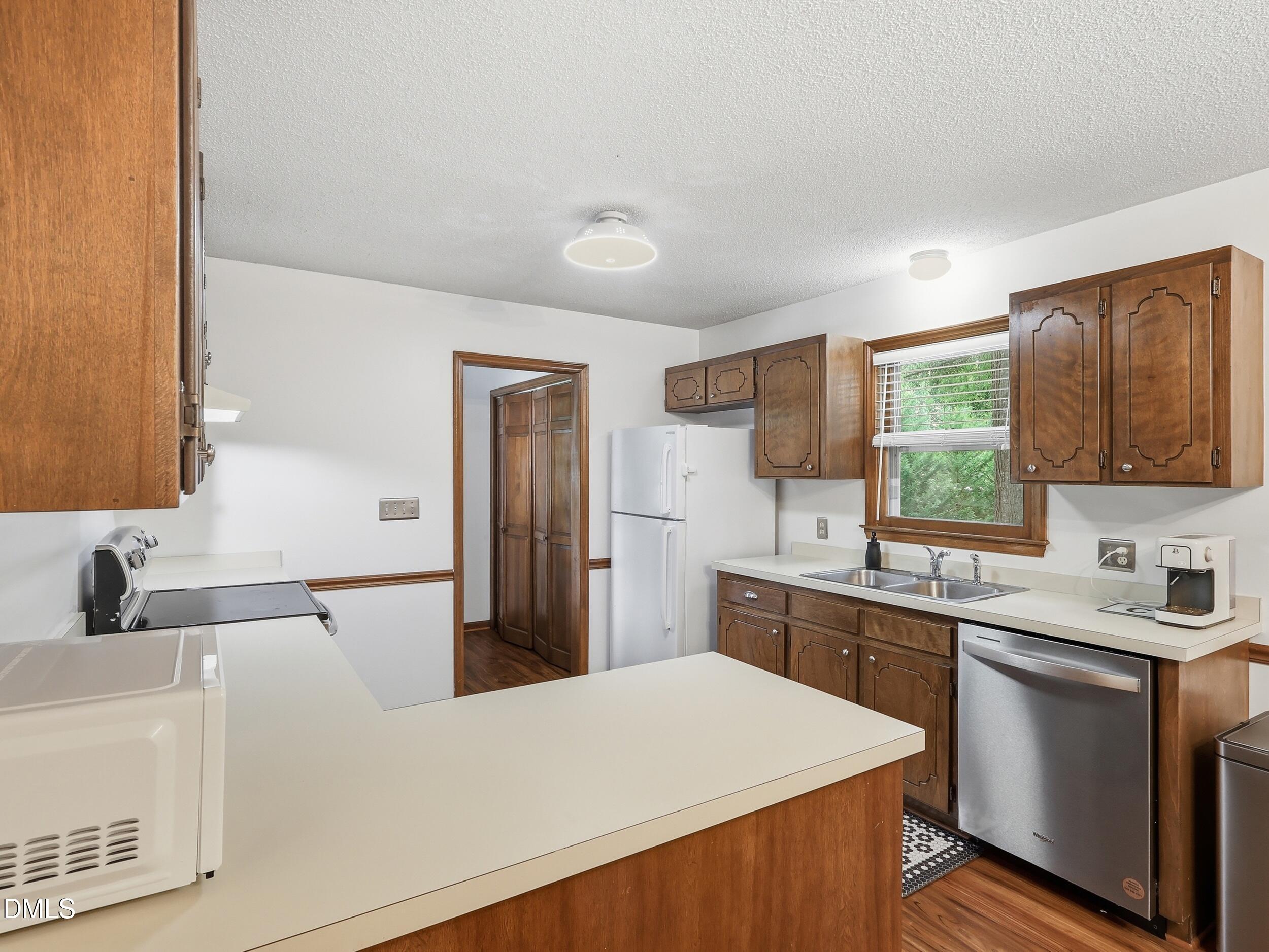 517 Lake Glad Road Wendell, NC 27591 - Photo 13 of 36 a kitchen with a sink a stove top oven a counter space and cabinets