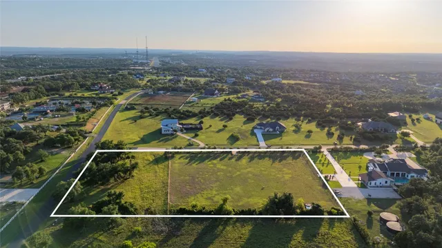 a view of a swimming pool with a chair and mountains in the background