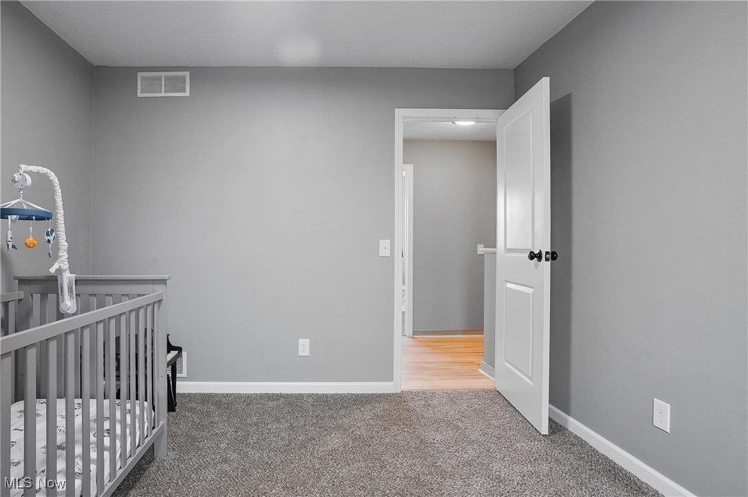 9278 Bryant Road Windham, OH 44288 - Photo 25 of 47 Bedroom with a nursery area and light carpet