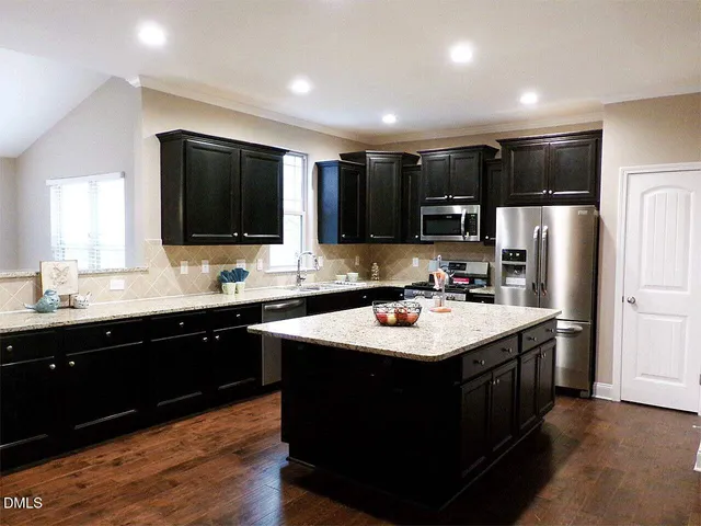 a kitchen with a sink stove top oven and refrigerator