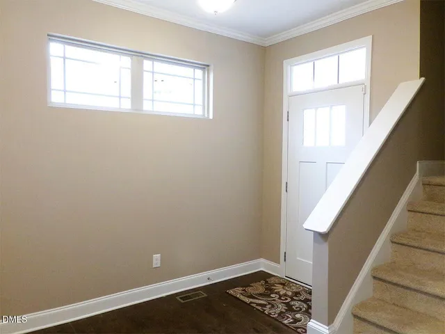 a view of wooden floor in a room with a window